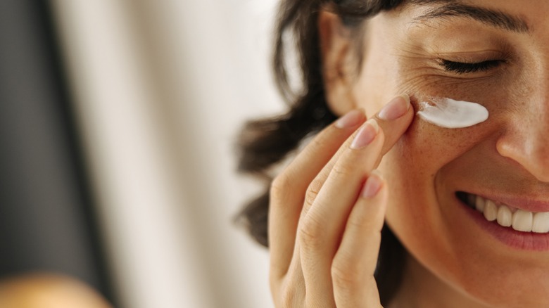 Applying eye cream