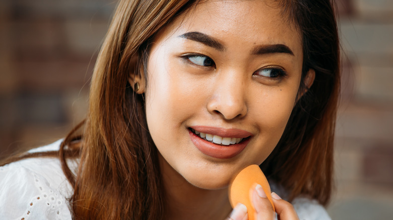 Woman applying makeup