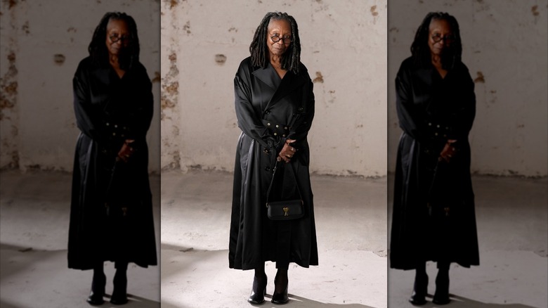 Whoopi Goldberg posing in a black coat in 2025