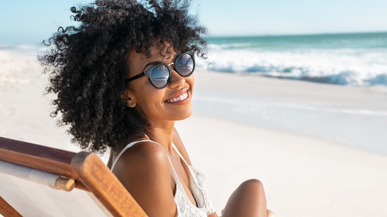 Woman lounging by beach
