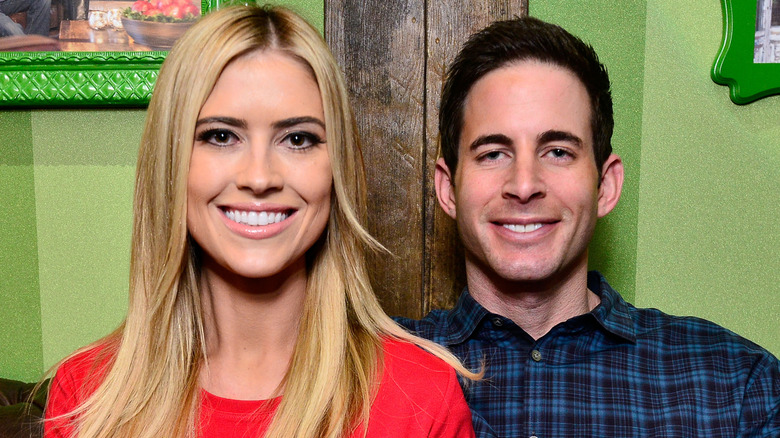 Christina Haack in a red shirt and Tarek El Moussa in a plaid shirt at an event
