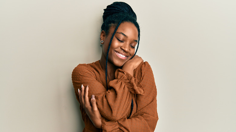 woman hugging herself