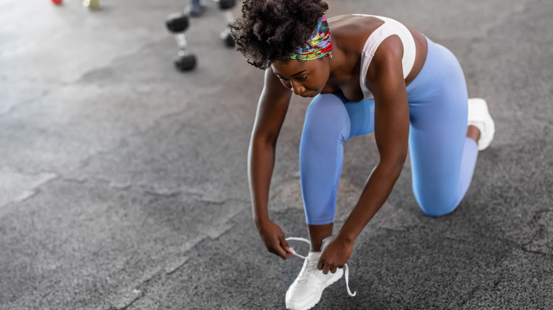 Woman tying shoes for workout