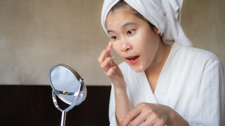 Applying concealer