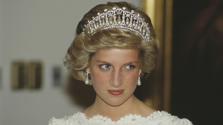 Princess Diana shown from the shoulders up wearing an evening dress and crown in 1985