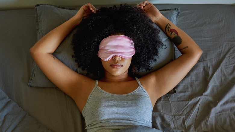 Woman smiling with eye mask