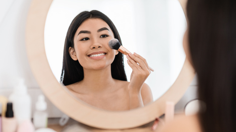 Woman applying makeup 