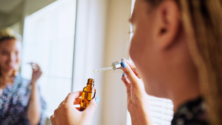 Woman holding face serum