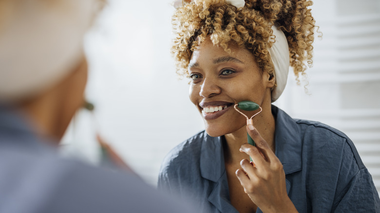 woman using face roller