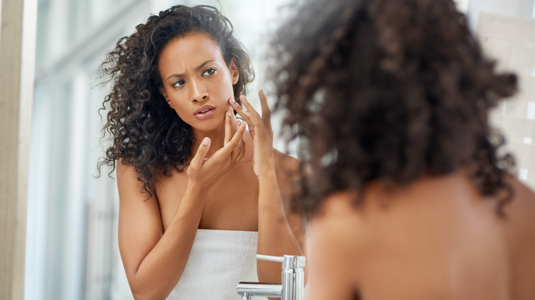 Touching face in mirror