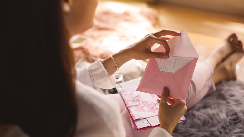 Woman opening letter