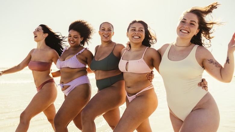 Group of five women in swimsuits