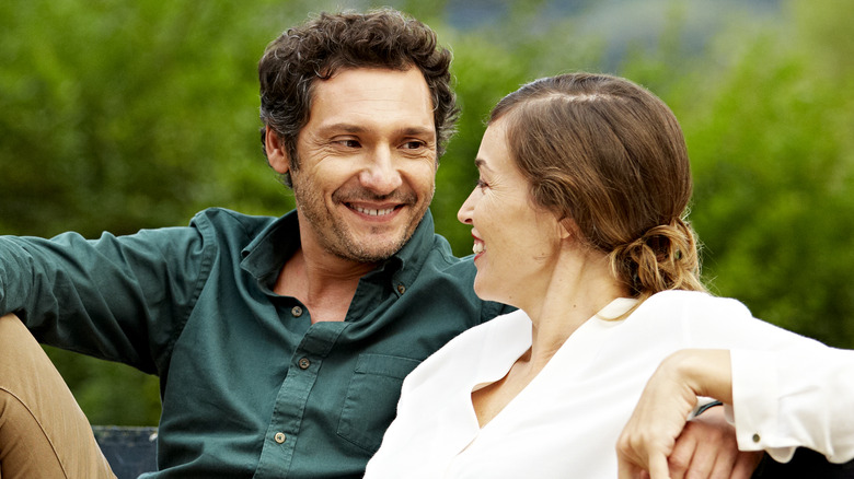 smiling couple sitting on bench
