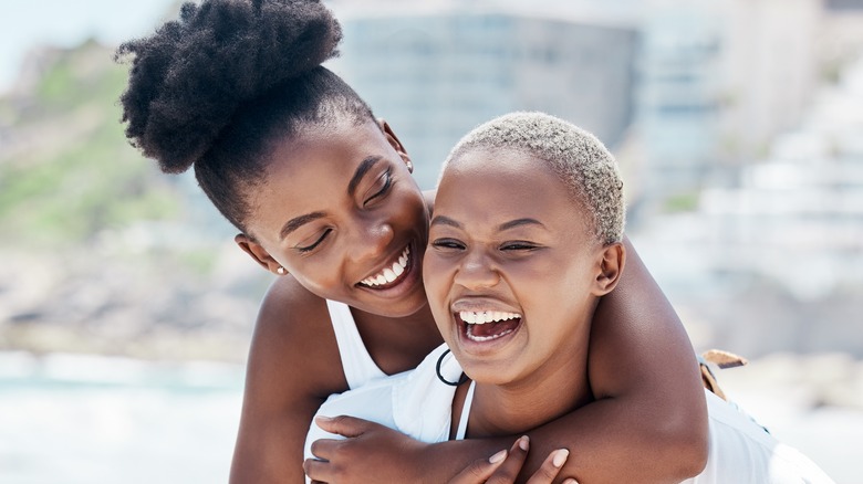 two women smiling at beach