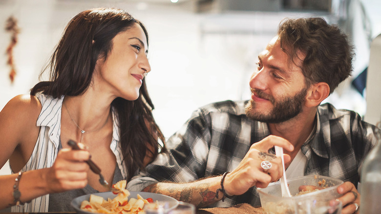 smiling couple eating dinner together