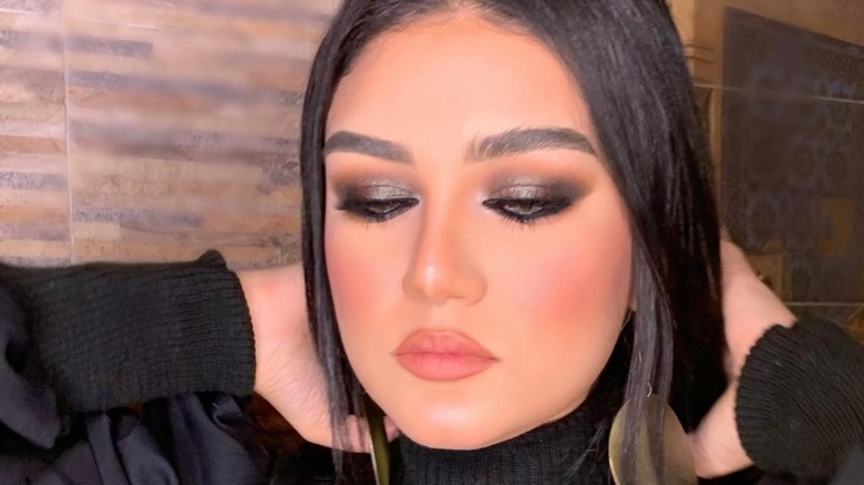 A woman wearing shimmery smoky eyes