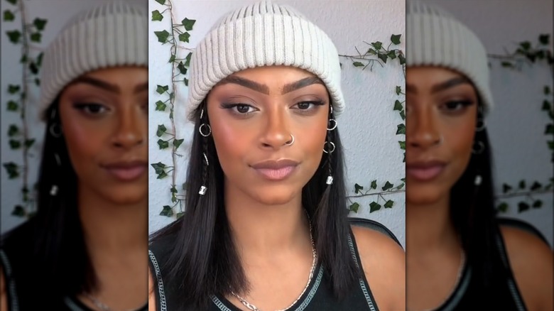 Woman wearing hair accessories and a hat