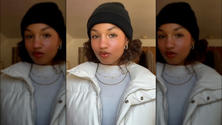 Woman with hair buns and a hat