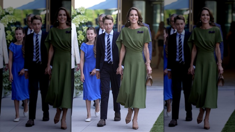 Catherine, Princess of Wales, walking in a green dress with her son Prince George and daughter Princess Charlotte behind her