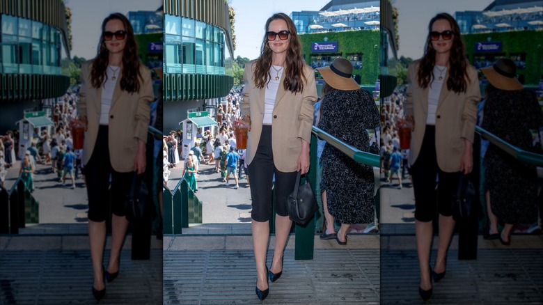 Michelle Dockery wearing a tan blazer and black capris