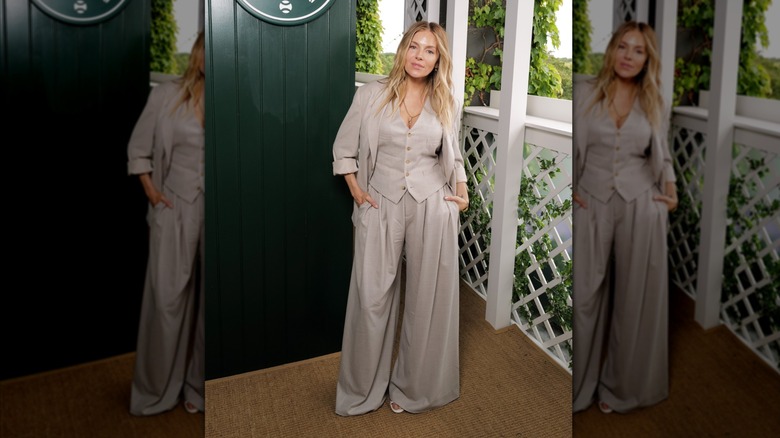 Sienna Miller wearing a three-piece suit with a relaxed, oversized fit