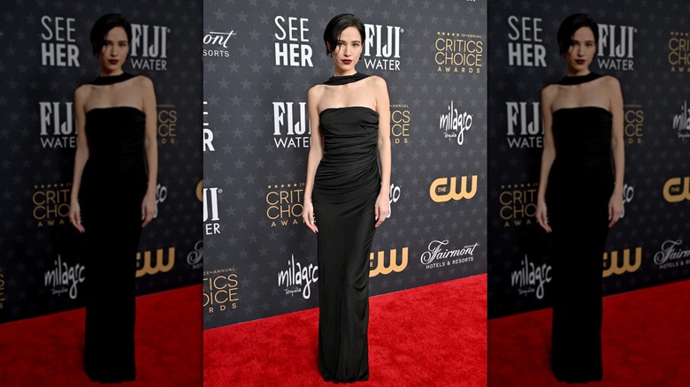 Kelsey Asbille wearing a black Saint Laurent floor length dress