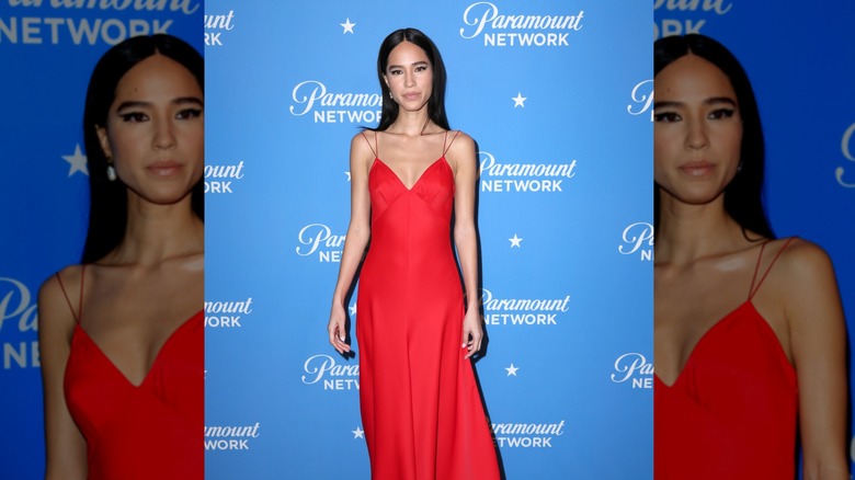 Kelsey Asbille wearing a long red gown with spagetti straps