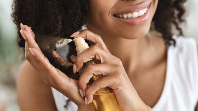 Woman spraying heat protectant 