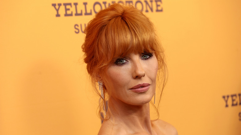 Kelly Reilly poses with copper hair and dark eye makeup