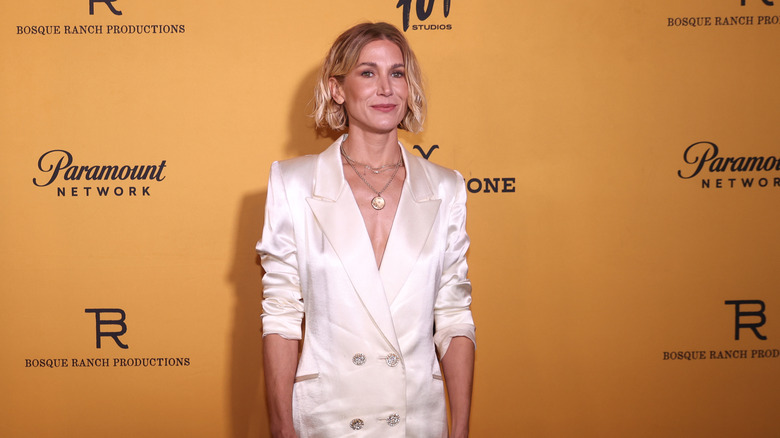 Jennifer Landon wearing a white suit on the red carpet