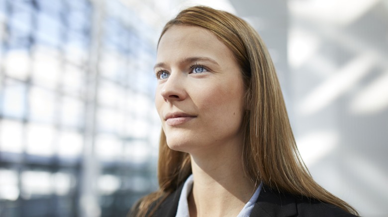 A woman with bright blue eyes looking away from the camera