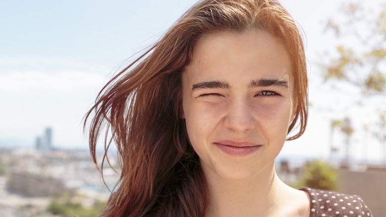 A woman squinting in the sun