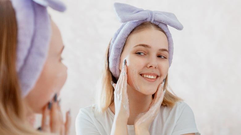 Woman washes her face