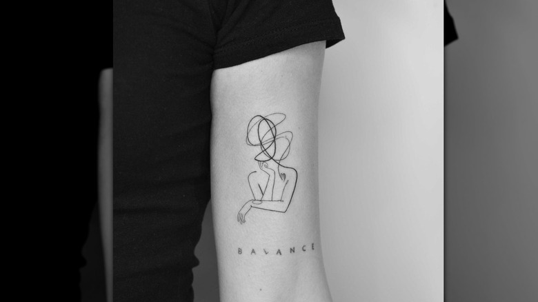 person with upper arm tattoo