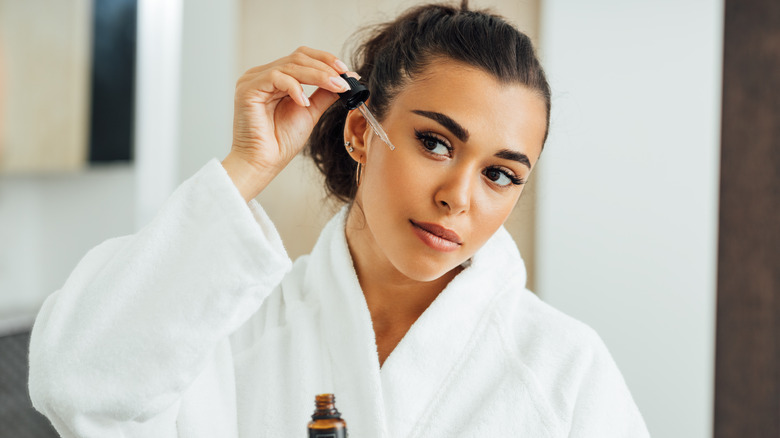 Woman applying serum