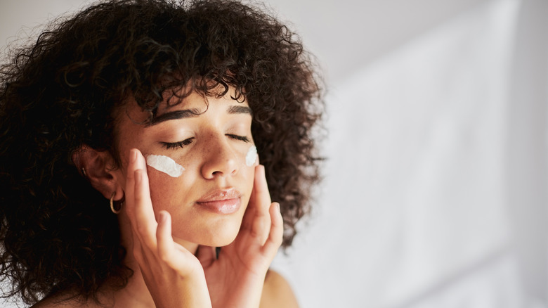 Woman applying sunscreen