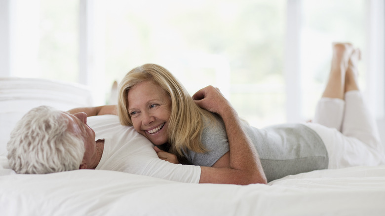 couple in bed laughing