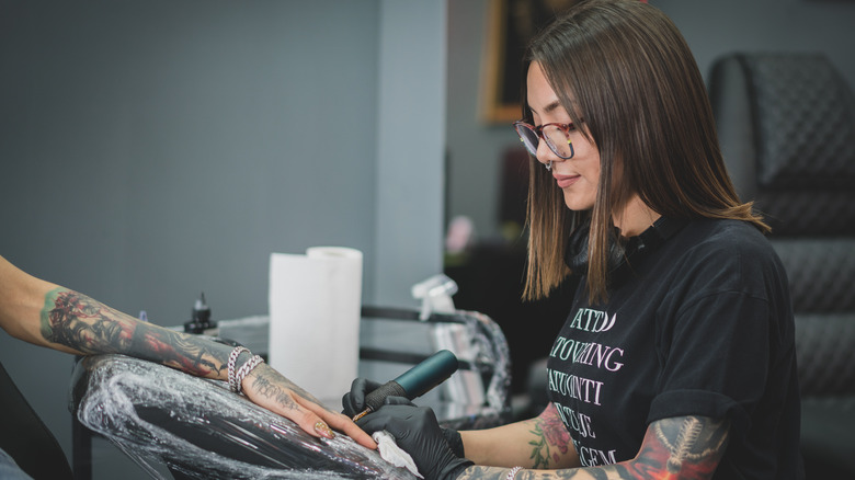 Tattoo artist working