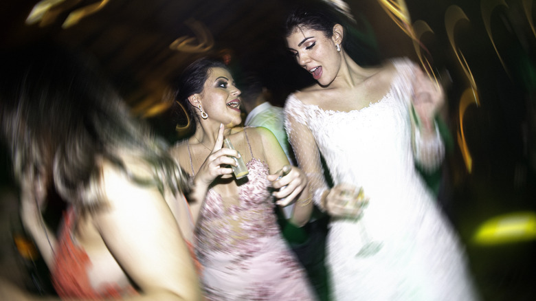 friend dancing with the bride