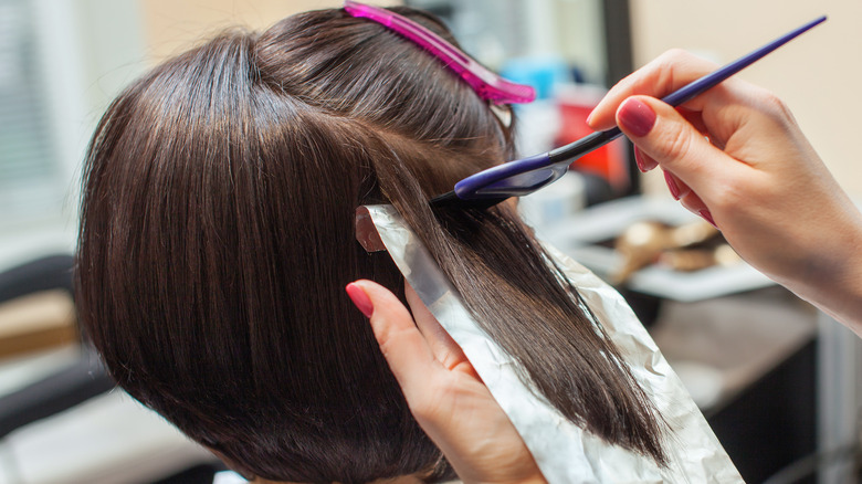 Woman receiving hair foilyage