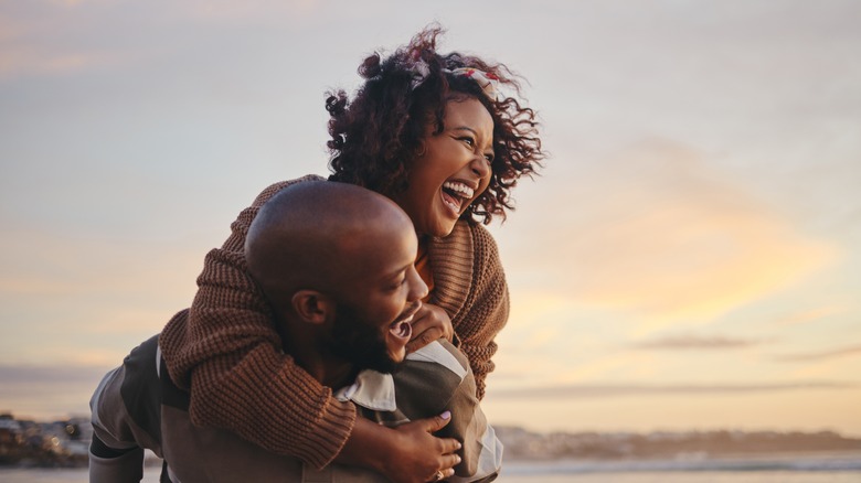 Couple laughing on the beach