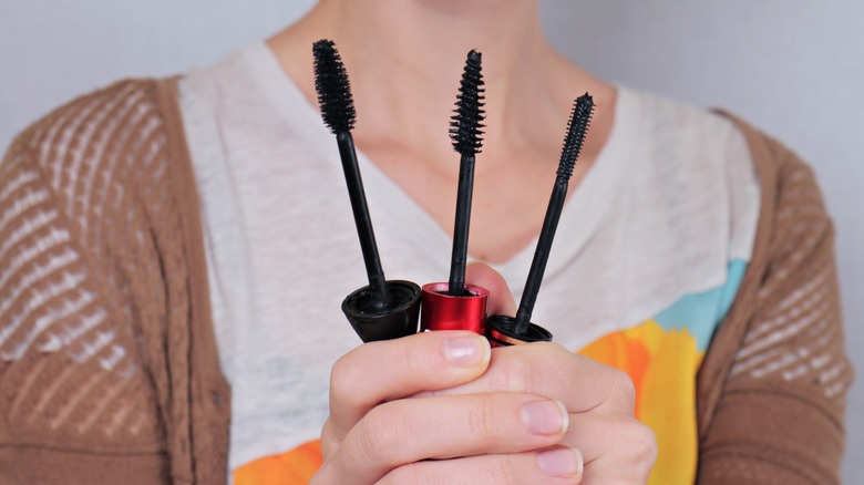 Woman holding mascara wands