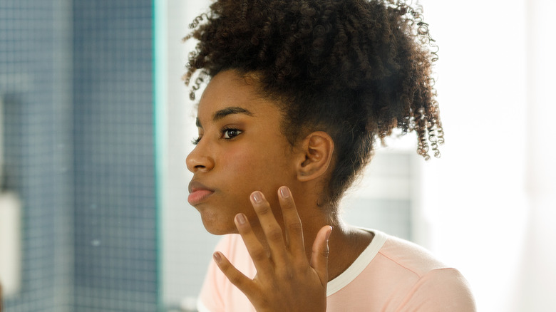 Woman touching her face