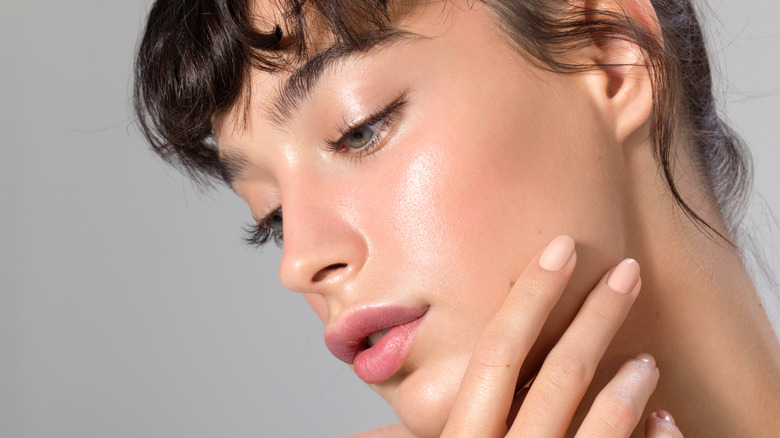 Woman with glowing skin and freshly polished nails