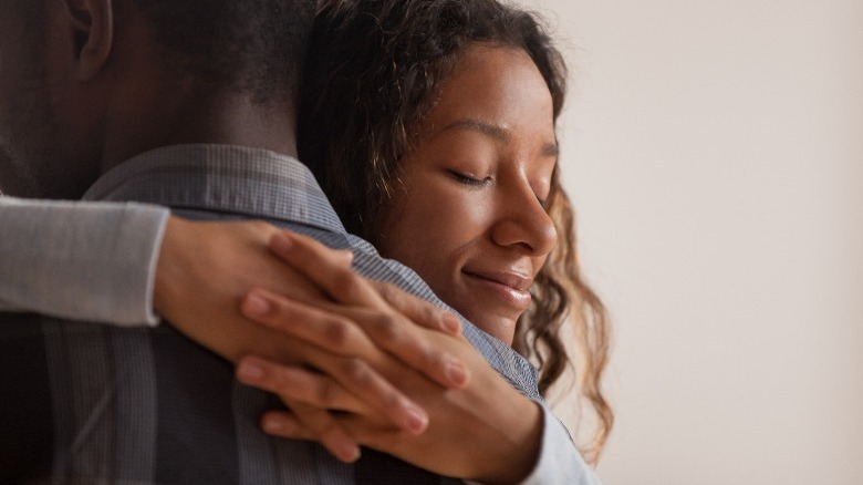 Woman embracing partner