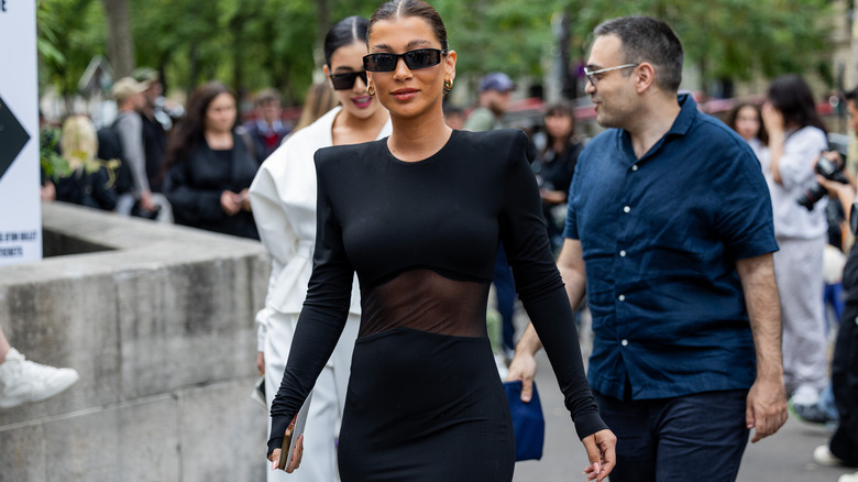 women in sheer-paneled gown