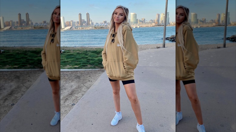 A woman in a hoodie and shorts