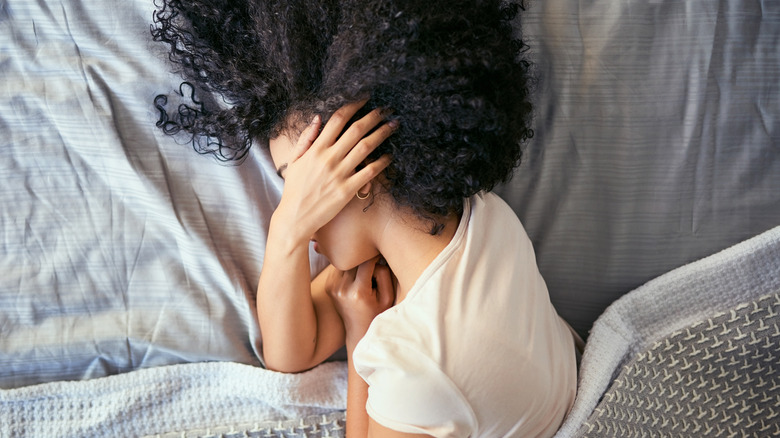 Woman in bed with headache