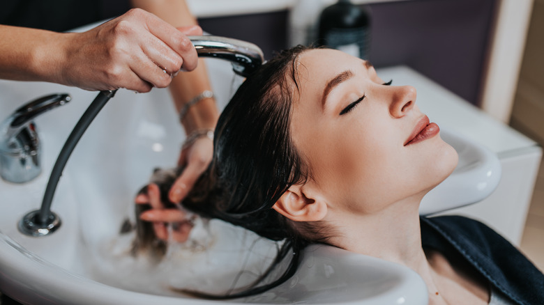 woman's hair washed at salon