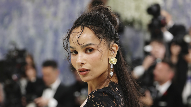 Zoë Kravitz on the red carpet in a black lace gown